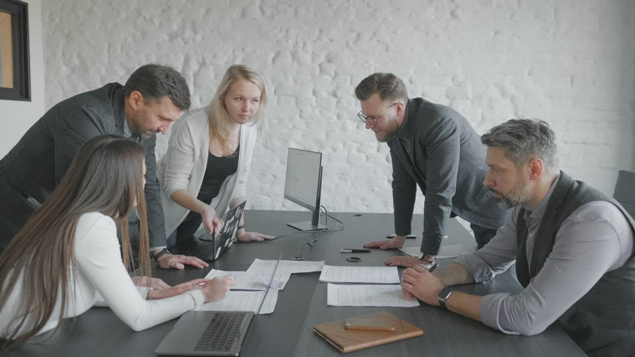 A team reviewing software milestone evidence together