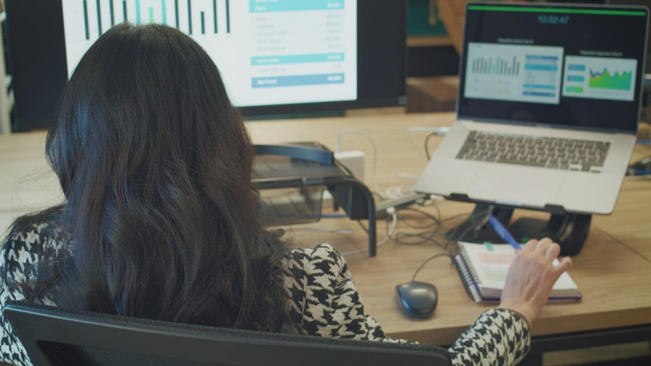 A facilitator reviewing delivery evidence across multiple screens