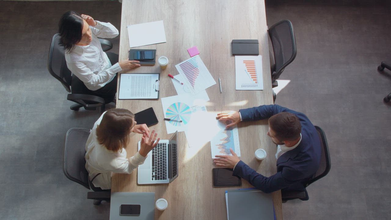 A product team coordinating verified delivery around a shared table